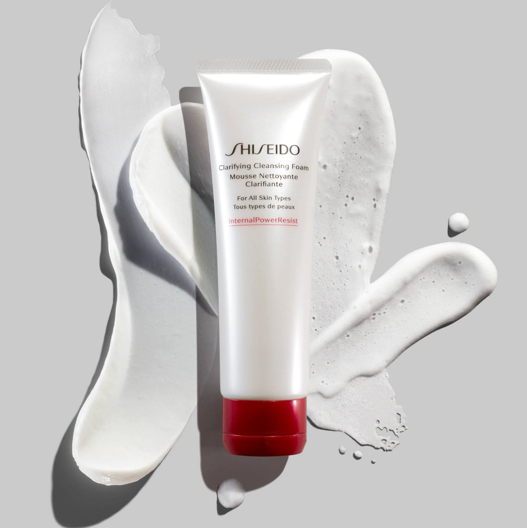 Shiseido cleansing foam tube with white cream on a gray background
