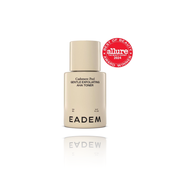 A bottle of EADEM Cashmere Peel AHA + PHA Exfoliating Toner with a beige label, displayed against a white background with a reflection below.