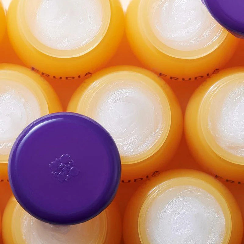 FRUDIA hydrating lip balm 10ml close-up showing a soft, nourishing consistency with a subtle shine