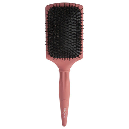 Fromm Pink paddle hair brush with black bristles on a white background
