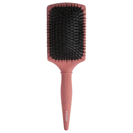Fromm Pink paddle hair brush with black bristles on a white background
