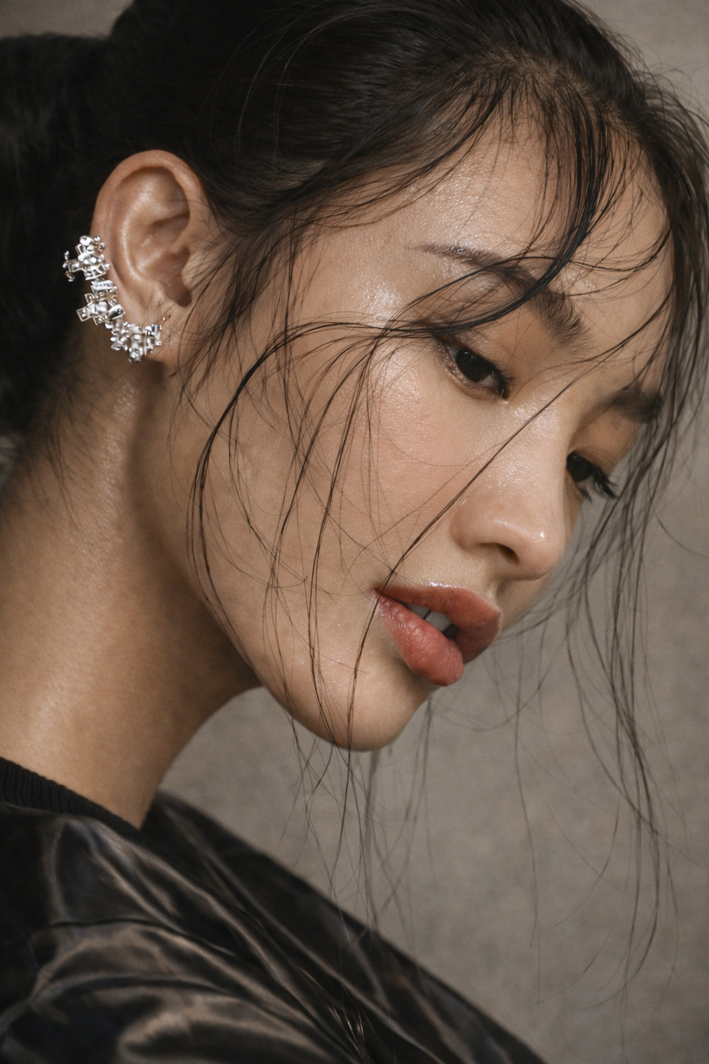 Editorial beauty portrait with luminous skin and statement crystal ear cuff