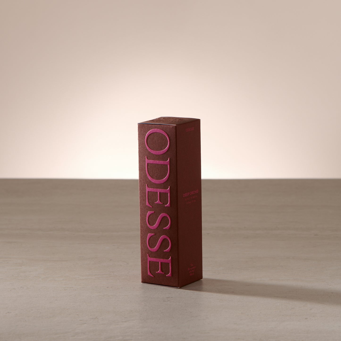 Odesse Deep Orchid 10ml extrait de parfum displayed in a soft, light-filled setting with a refined, portable format