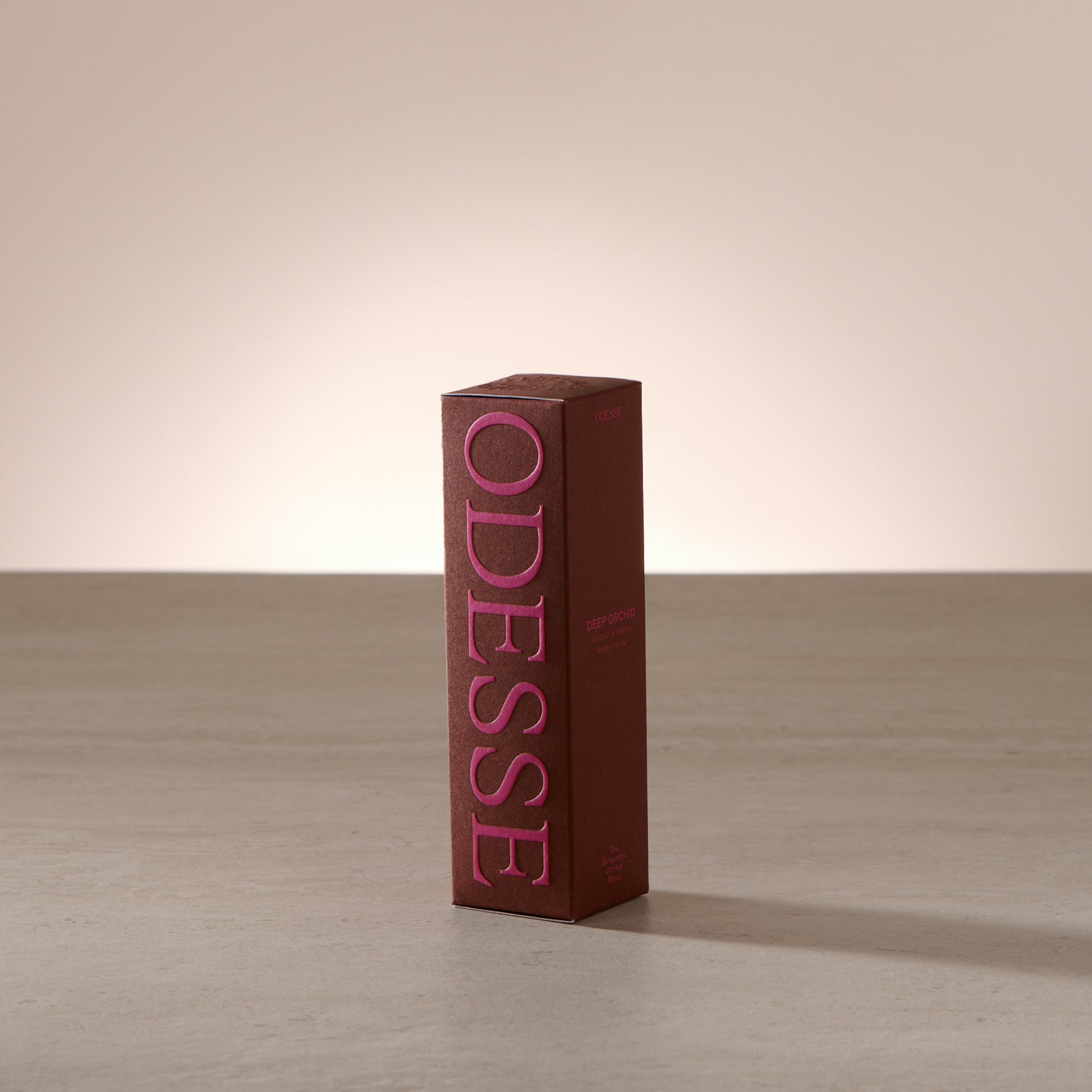 Odesse Deep Orchid 10ml extrait de parfum displayed in a soft, light-filled setting with a refined, portable format
