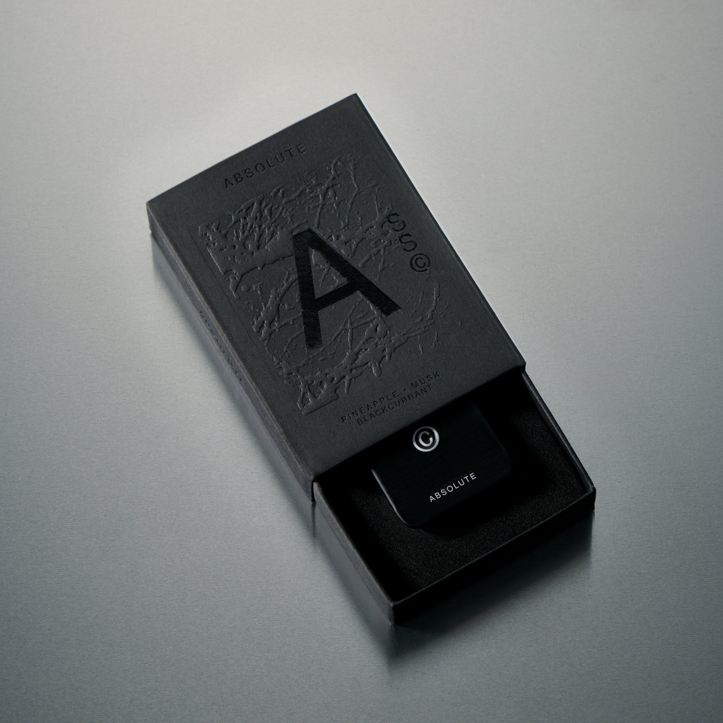 Solid State Absolute solid cologne formulated for refined fragrance delivery with a smooth, wax-based texture