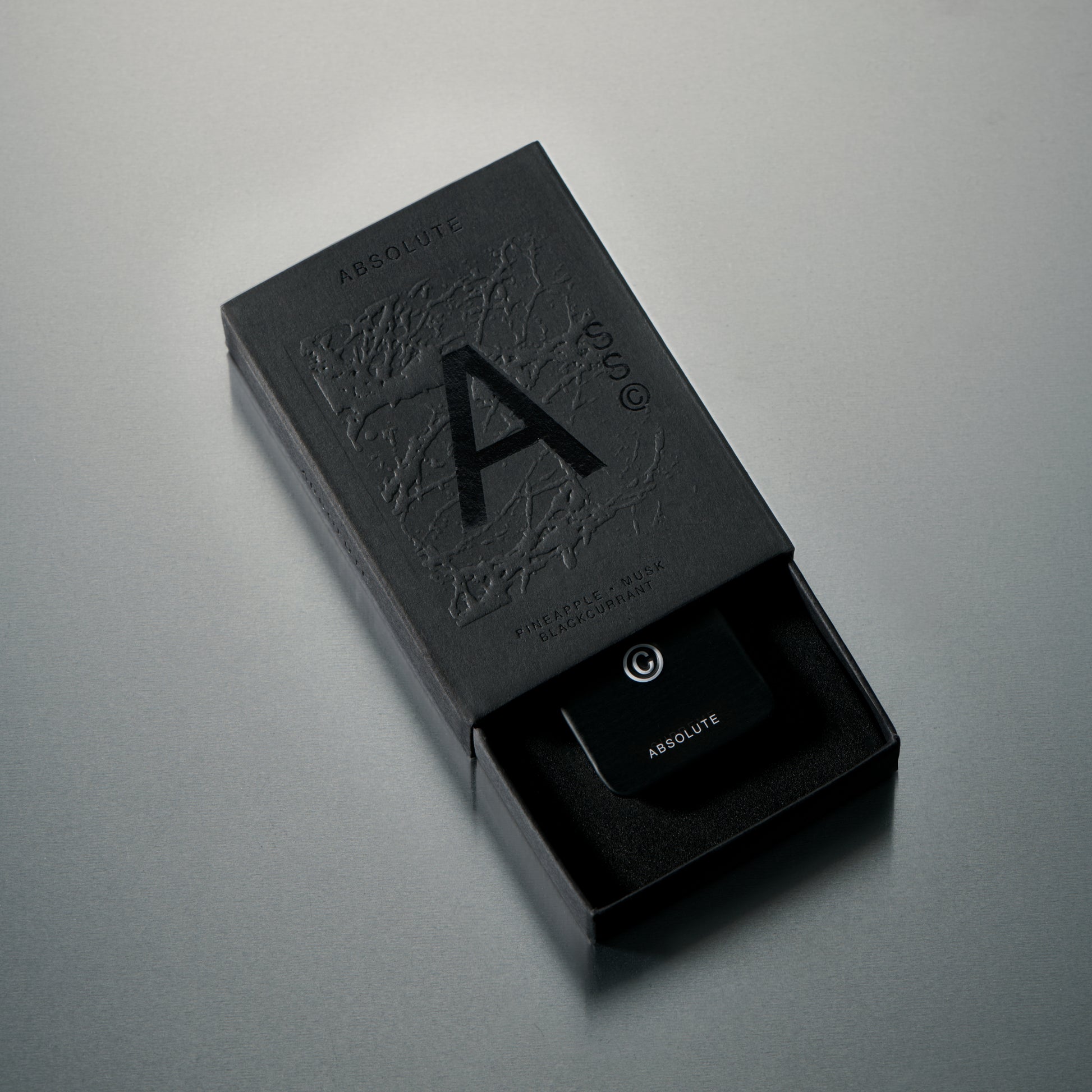 Solid State Absolute solid cologne formulated for refined fragrance delivery with a smooth, wax-based texture