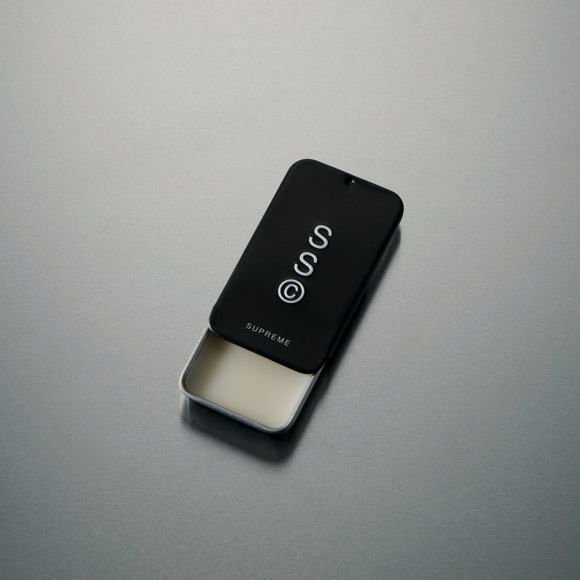 Solid State fragrance balm designed to deliver a refined scent in a discreet, portable format