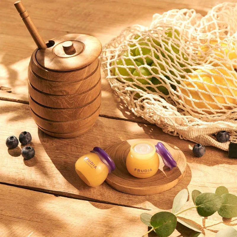 FRUDIA hydrating lip balm 10ml infused with blueberry extract and honey to support smooth, supple lips