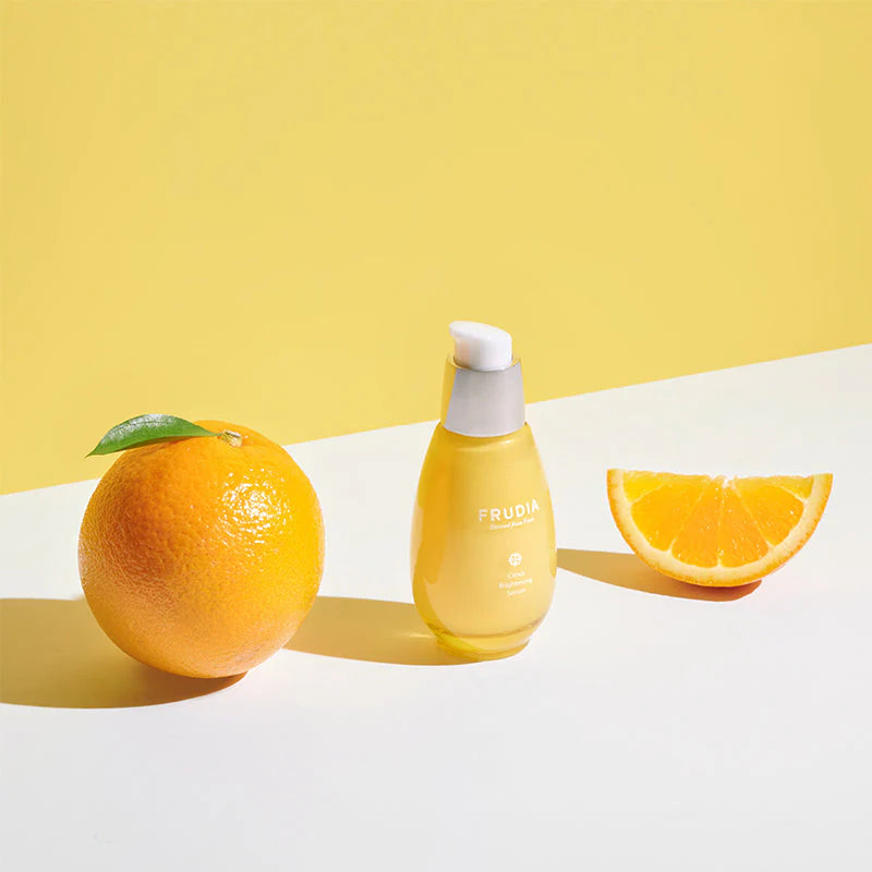 FRUDIA Citrus Brightening Serum 50g styled with fresh citrus elements highlighting radiance and skin clarity